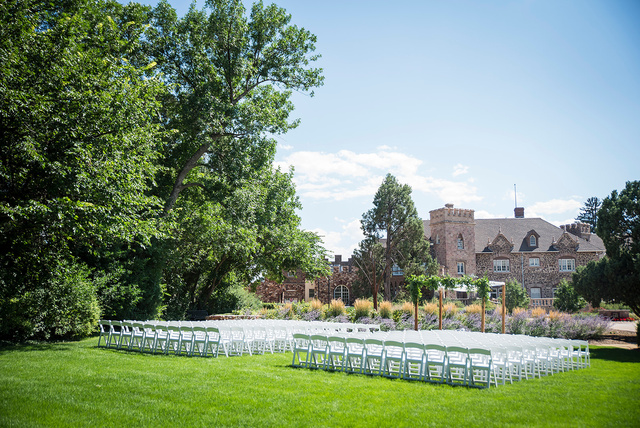 An outdoor wedding ceremony set up in front of the castle at Highlands Ranch Mansion in Colorado.