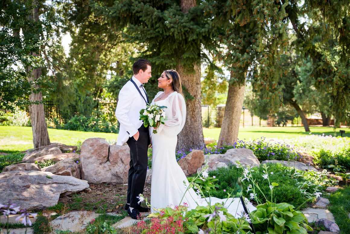 A bride and groom in the garden at Highlands Ranch Mansion in Colorado.